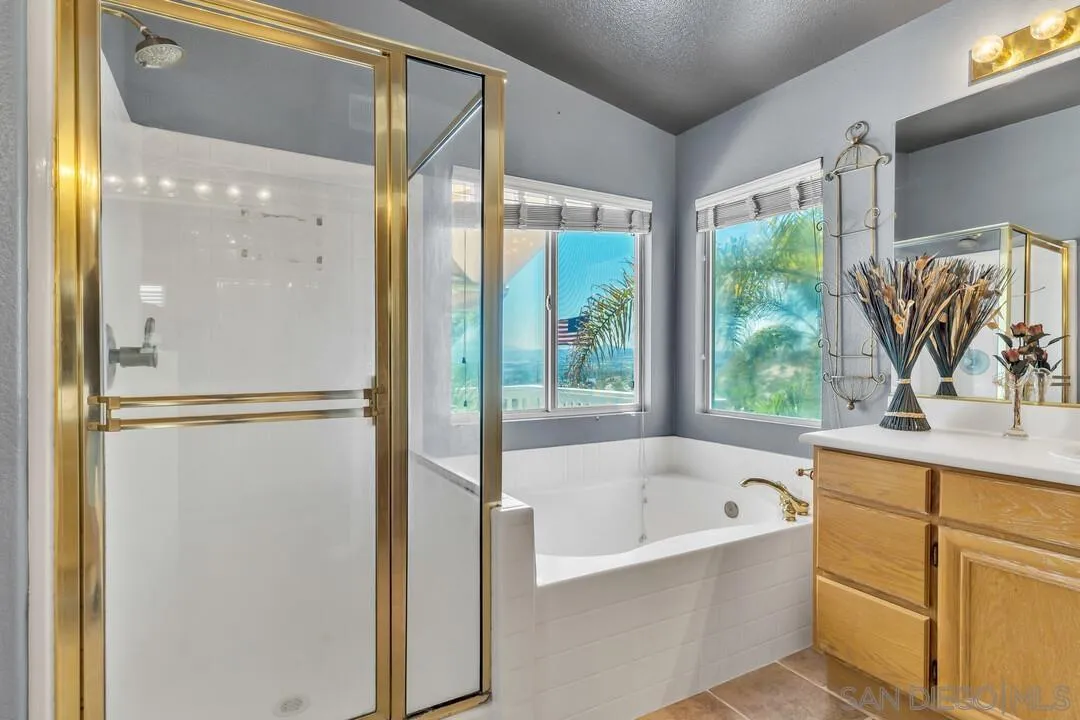 10496 Chaparral Drive Santee, CA 92071 - Photo 37 of 73 a bathroom with a bathtub and a shower