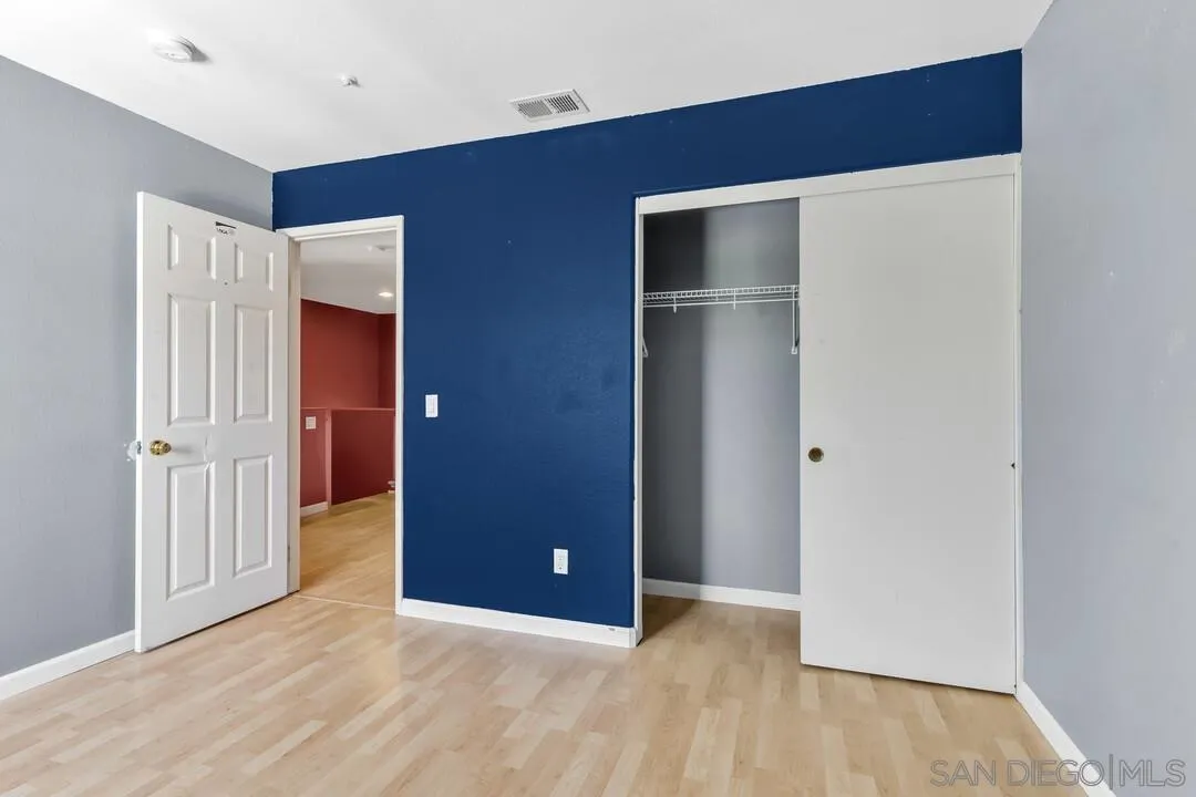 10496 Chaparral Drive Santee, CA 92071 - Photo 43 of 73 a view of an empty room with wooden floor and a bathroom