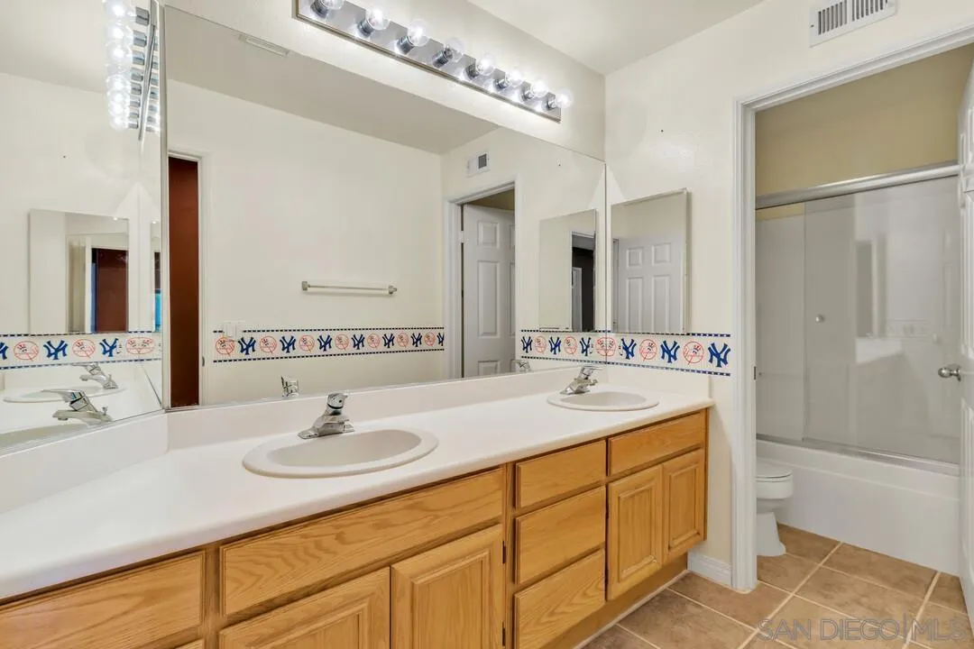 10496 Chaparral Drive Santee, CA 92071 - Photo 44 of 73 a bathroom with a sink double vanity and a mirror