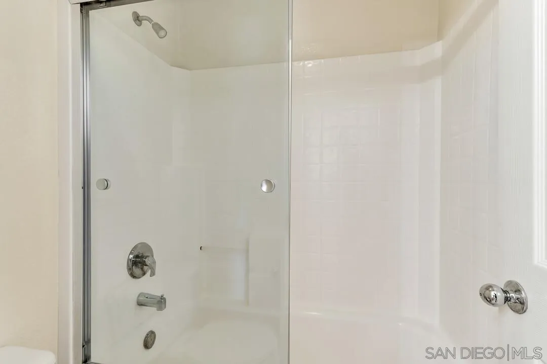 10496 Chaparral Drive Santee, CA 92071 - Photo 45 of 73 a bathroom with a glass shower door
