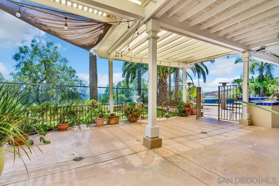 10496 Chaparral Drive Santee, CA 92071 - Photo 52 of 73 a view of a patio with a table and chairs under an umbrella