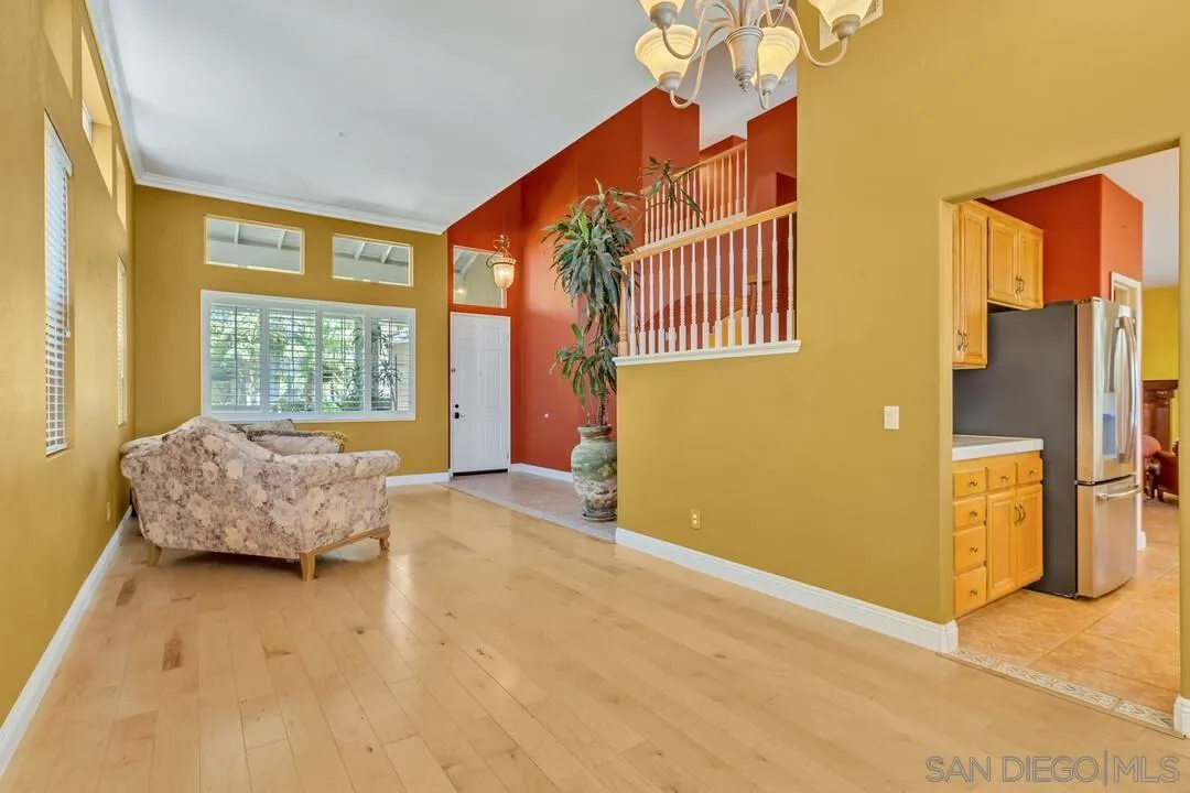 10496 Chaparral Drive Santee, CA 92071 - Photo 6 of 73 a spacious bedroom with a bed and a chandelier