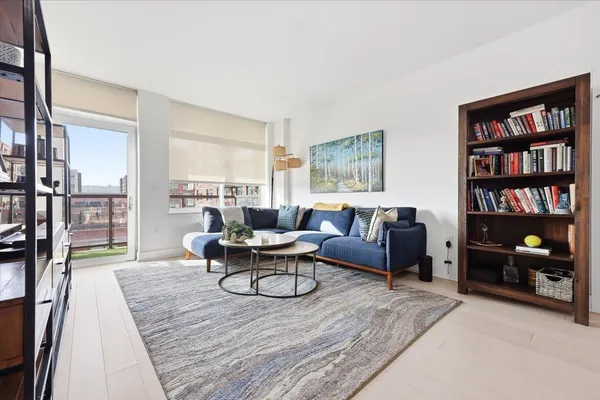 a living room with furniture and a book shelf