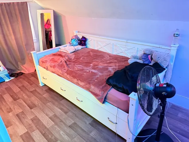 a bedroom with bed and window