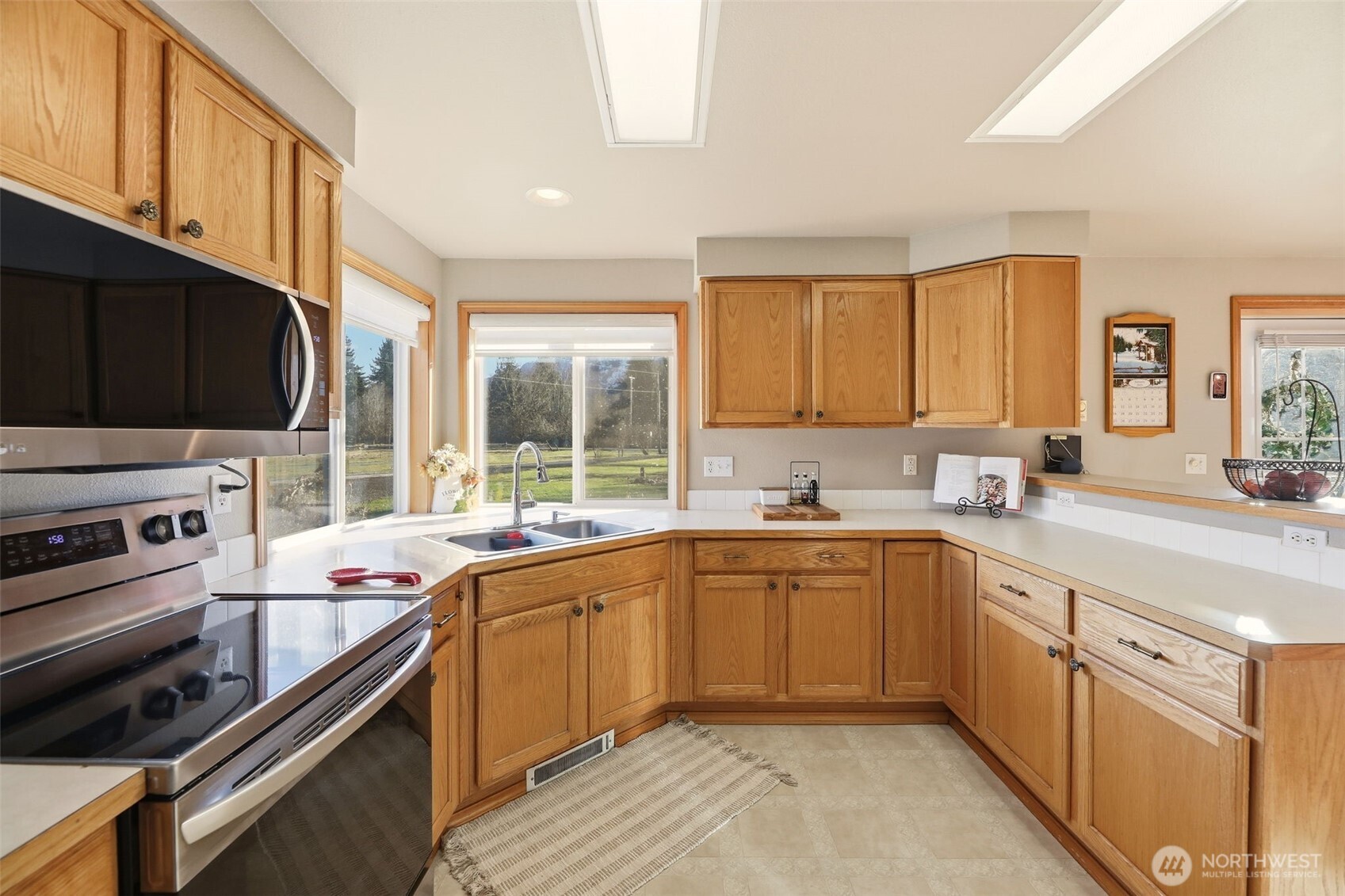 36721 Swede Heaven Road Arlington, WA 98223 - Photo 14 of 40 a kitchen with a sink stove top oven and cabinets