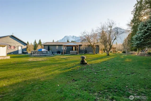 a house view with swimming pool in front of it
