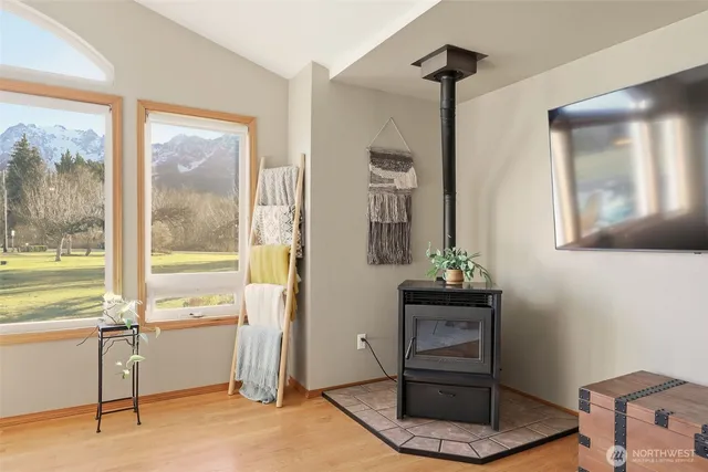 a room with painting on the wall and a potted plant