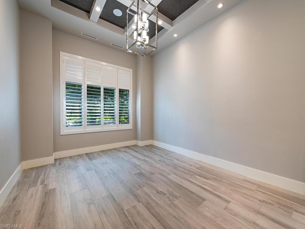 555 Mooring Line Drive Naples, FL 34103 - Photo 13 of 27 a view of an empty room with wooden floor and a window