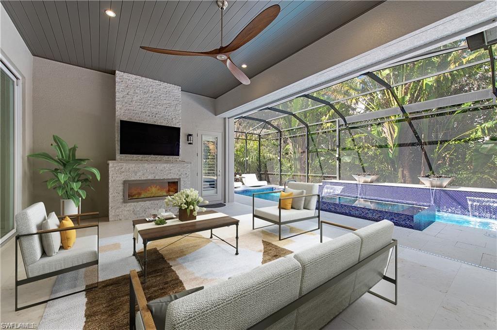555 Mooring Line Drive Naples, FL 34103 - Photo 15 of 27 a living room with fireplace furniture and a floor to ceiling window