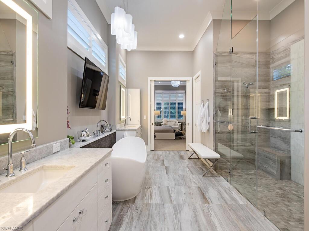 555 Mooring Line Drive Naples, FL 34103 - Photo 16 of 27 a spacious bathroom with a double vanity sink a mirror and a shower