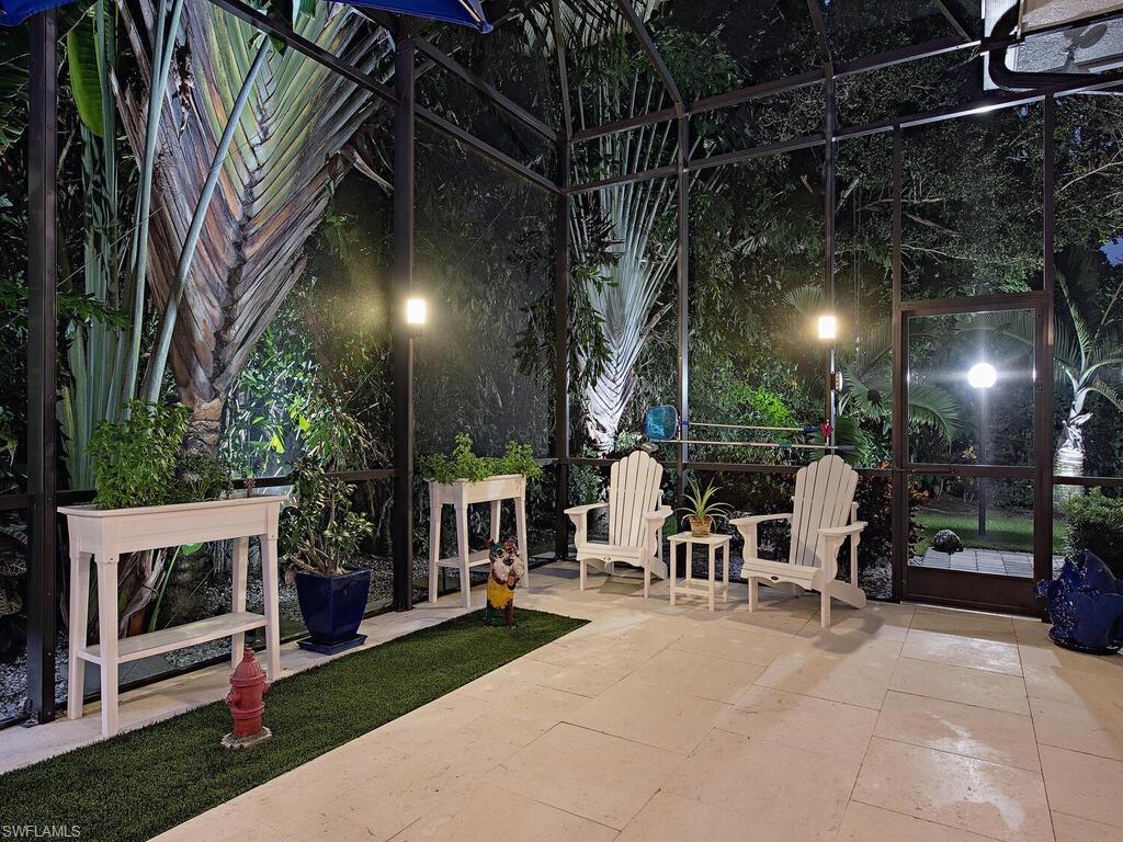 555 Mooring Line Drive Naples, FL 34103 - Photo 19 of 27 a view of a chairs and tables in patio with a fire pit and wooden fence