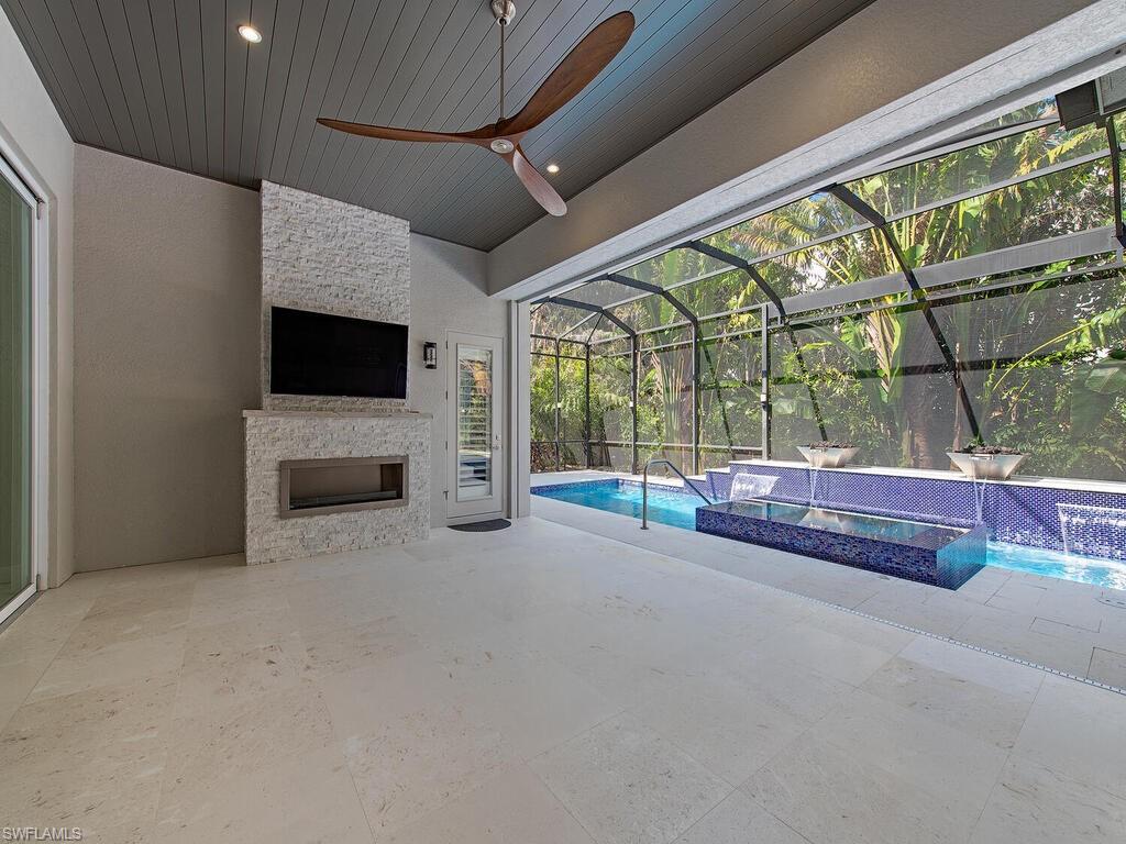 555 Mooring Line Drive Naples, FL 34103 - Photo 20 of 27 a view of an empty room with a fireplace and a window