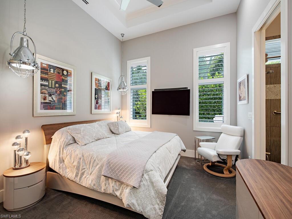 555 Mooring Line Drive Naples, FL 34103 - Photo 24 of 27 a bedroom with a bed and wooden floor