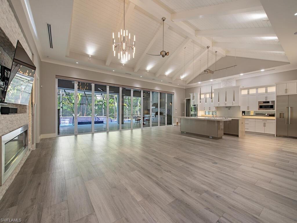 555 Mooring Line Drive Naples, FL 34103 - Photo 3 of 27 a view of a big room with wooden floor and a kitchen