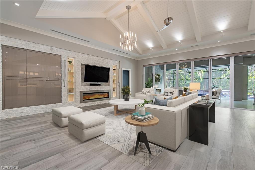 555 Mooring Line Drive Naples, FL 34103 - Photo 4 of 27 a living room with fireplace furniture and a flat screen tv