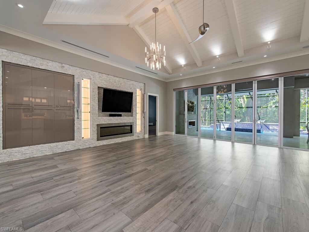 555 Mooring Line Drive Naples, FL 34103 - Photo 6 of 27 a view of an empty room with wooden floor and a window