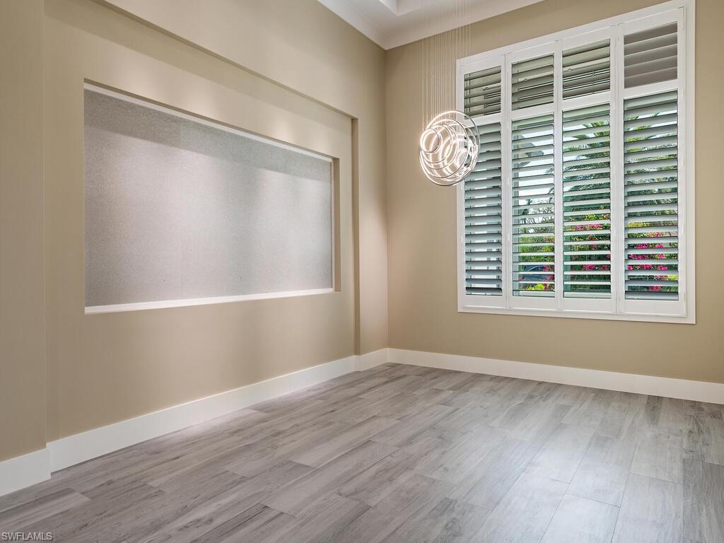 555 Mooring Line Drive Naples, FL 34103 - Photo 10 of 27 a view of empty room with wooden floor and fan