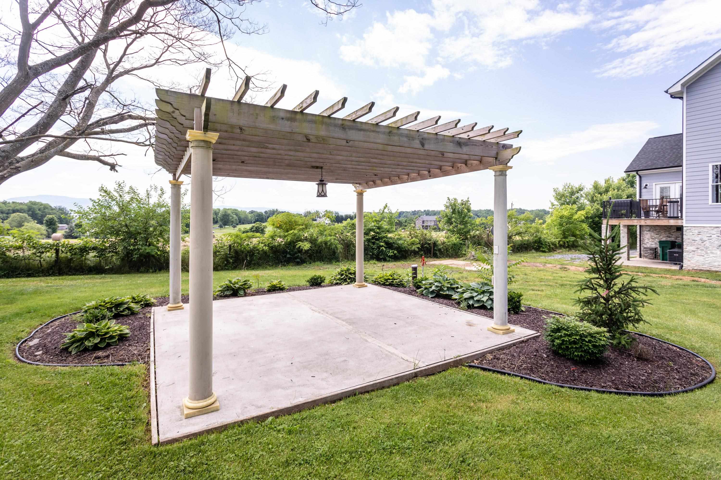 8426 East Timber Ridge Road Mount Crawford, VA 22841 - Photo 10 of 57 a view of a patio with a table and chairs under an umbrella