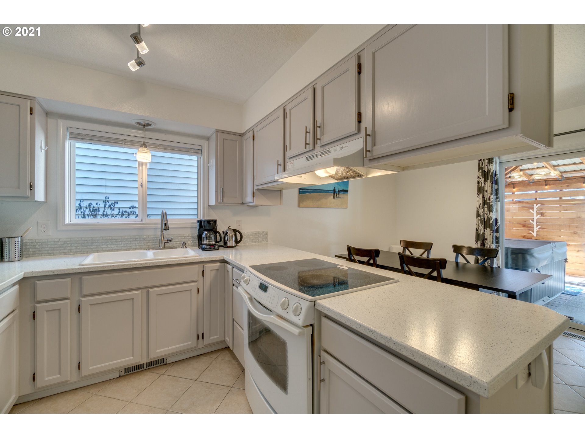 16934 Southwest Steele Way Beaverton, OR 97006 - Photo 7 of 27 a kitchen that has a sink and a stove