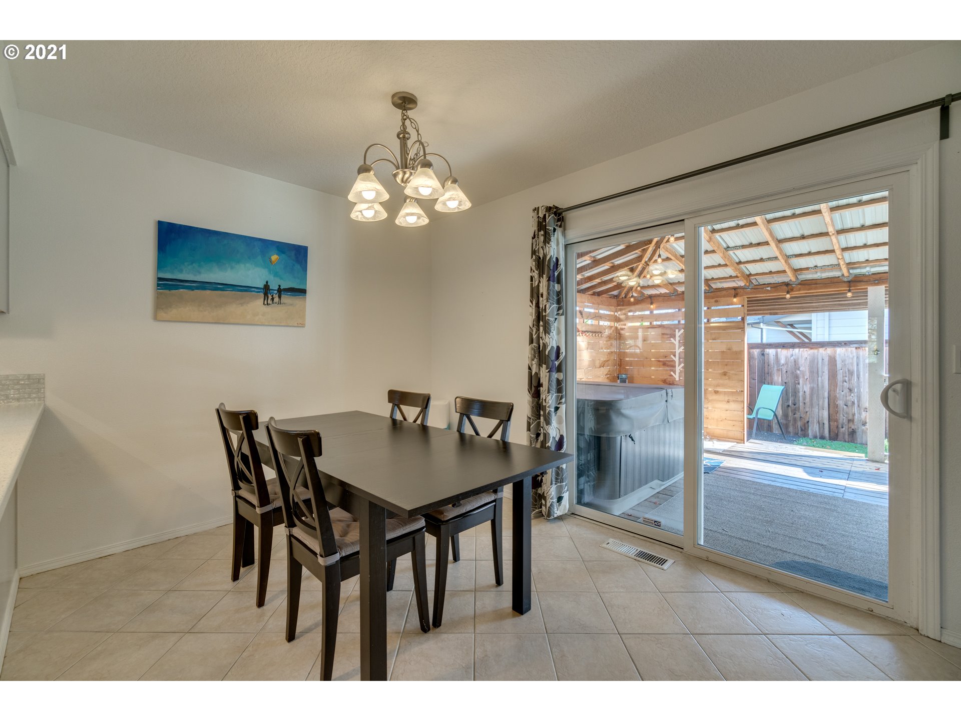 16934 Southwest Steele Way Beaverton, OR 97006 - Photo 10 of 27 a view of a dining room with furniture and a chandelier