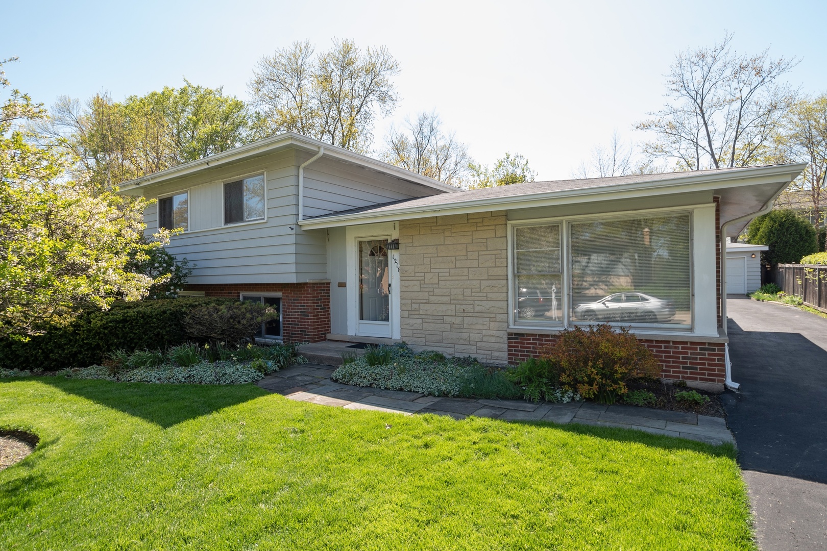 1218 Kenton Road Deerfield, IL 60015 - Photo 1 of 15 a front view of house with yard and green space