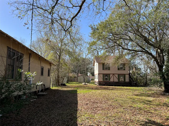 a view of a yard with a large tree