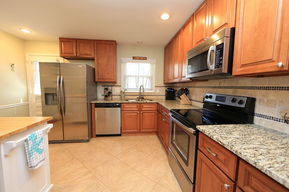 6509 Keystone Drive Raleigh, NC 27612 - Photo 3 of 12 with Stainless Steel Appliances and a great view of the backyard. Kitchen has Tile Floors and Granite Counter Tops