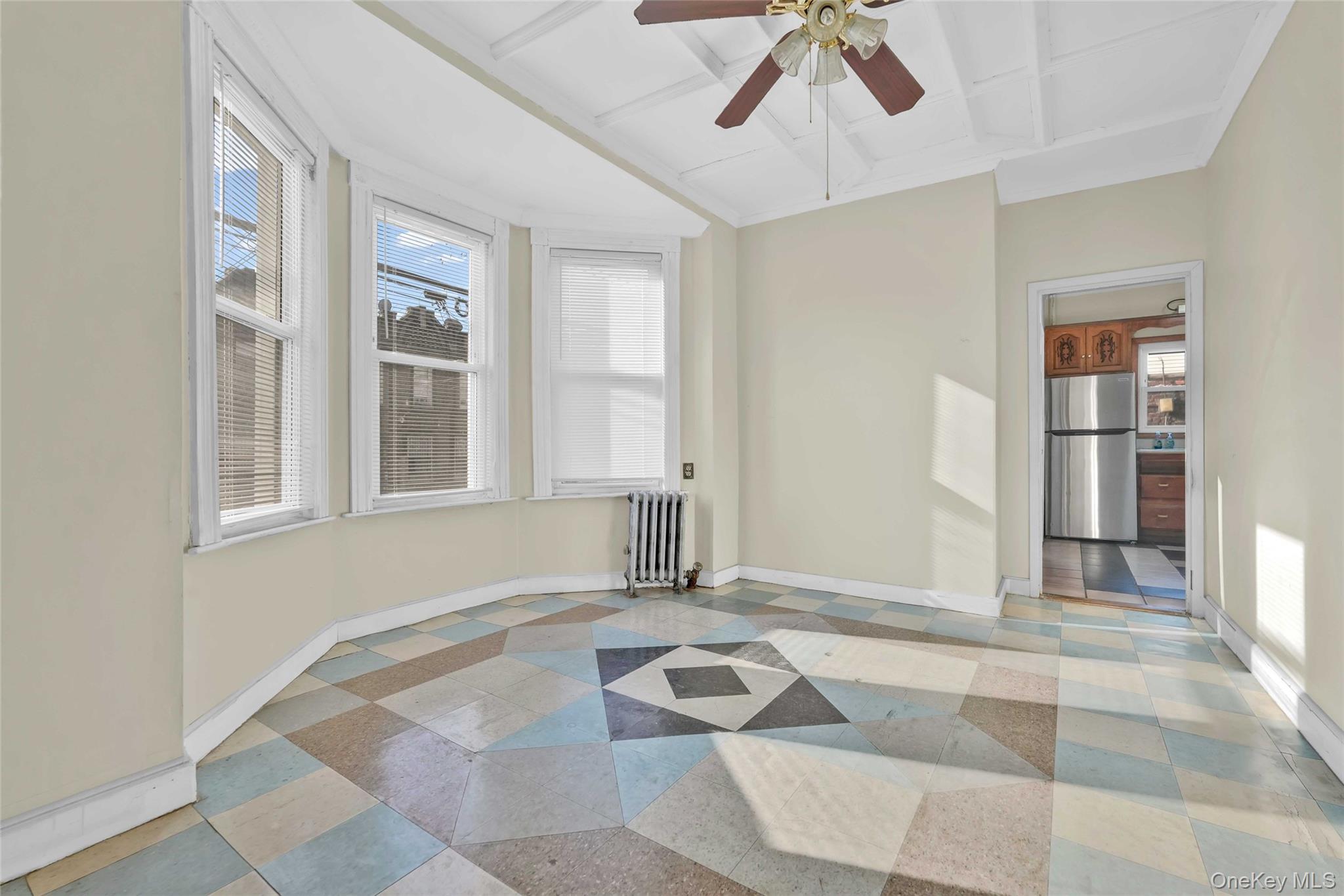 194 Crystal Street Brooklyn, NY 11208 - Photo 2 of 16 a view of a livingroom with wooden floor and a ceiling fan