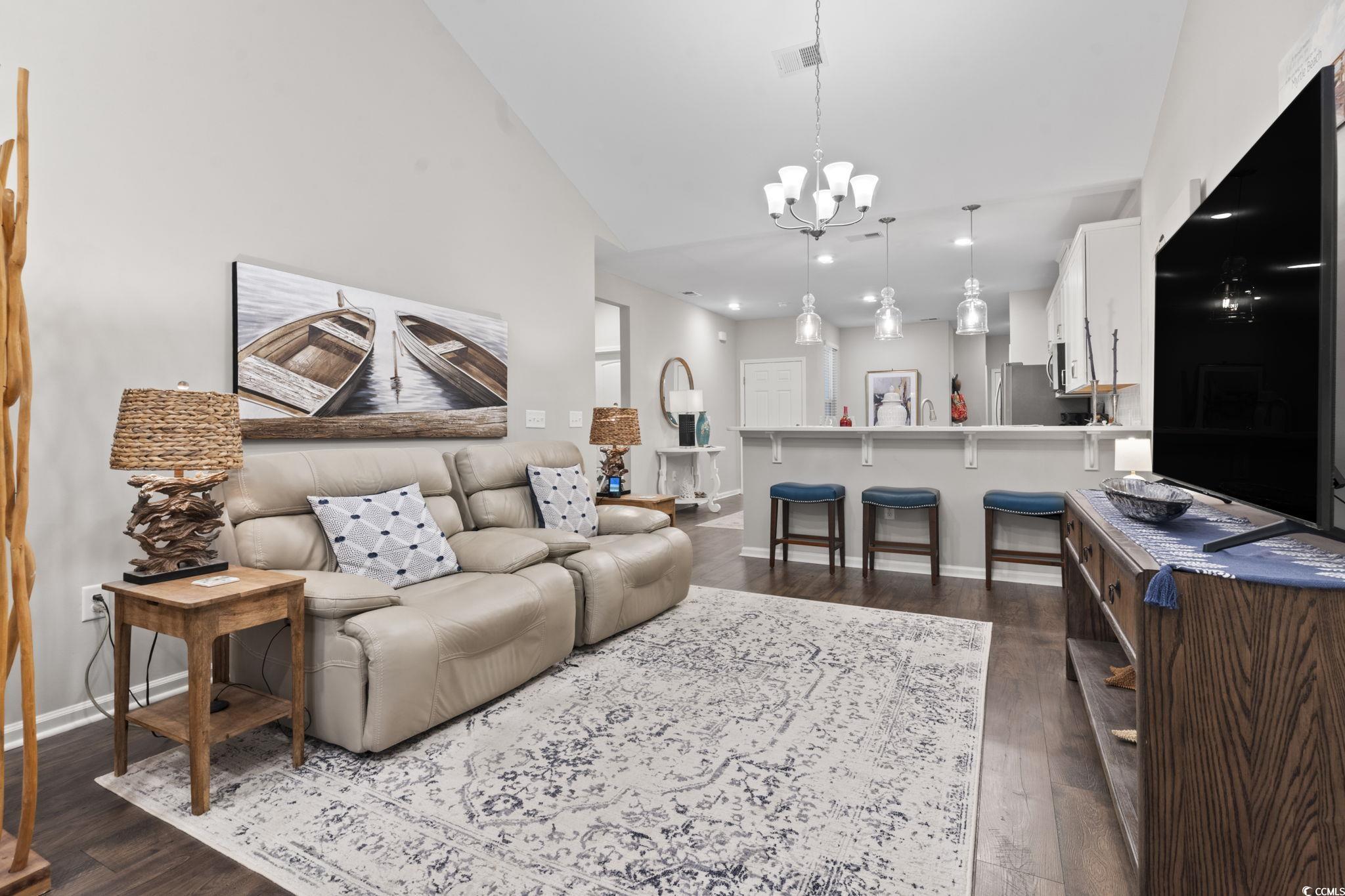 4027 Taranto Loop, Unit C Myrtle Beach, SC 29579 - Photo 12 of 36 Living room featuring a chandelier, baseboards, da