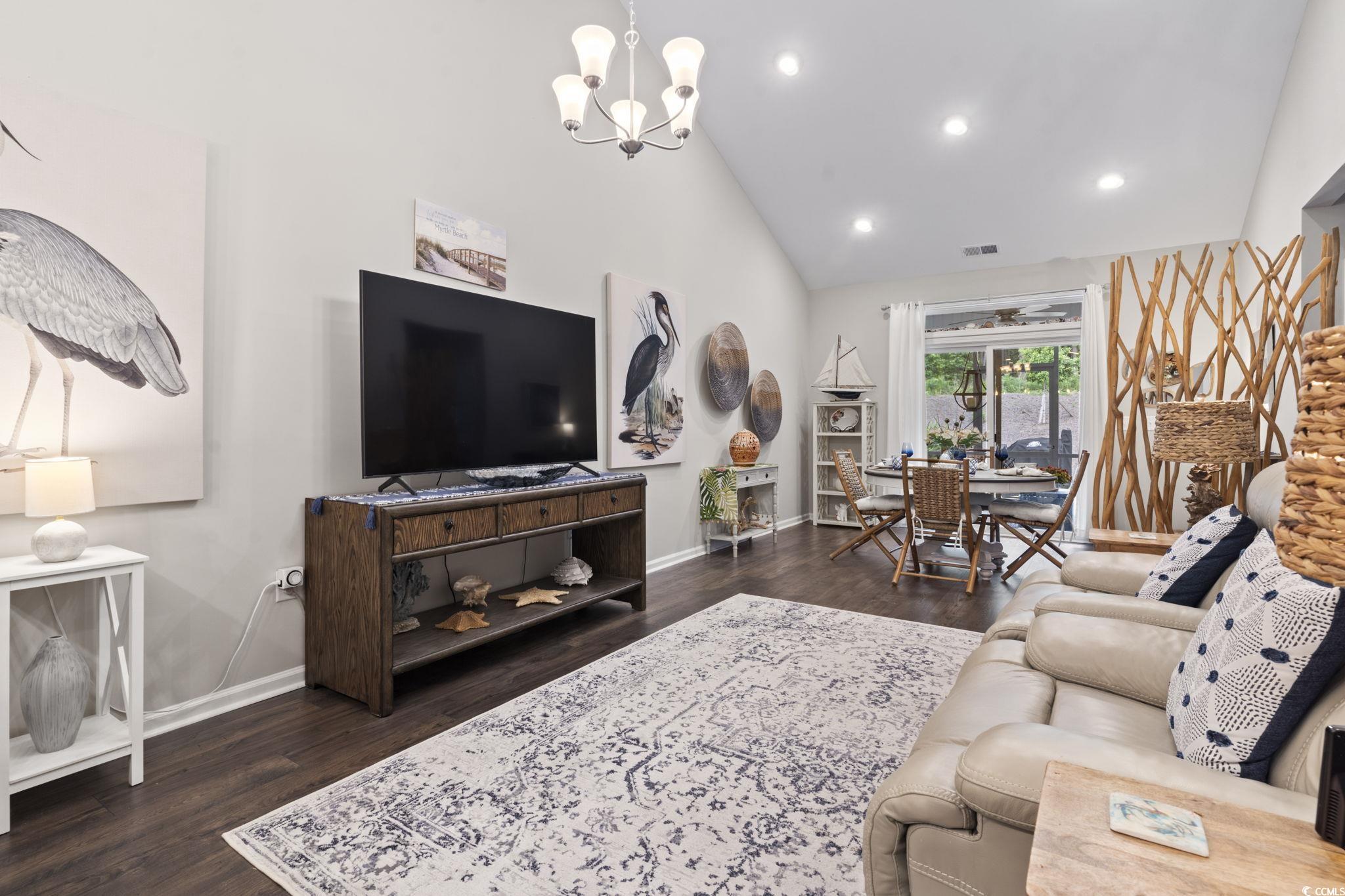 4027 Taranto Loop, Unit C Myrtle Beach, SC 29579 - Photo 13 of 36 Living room with dark wood-type flooring, a chande