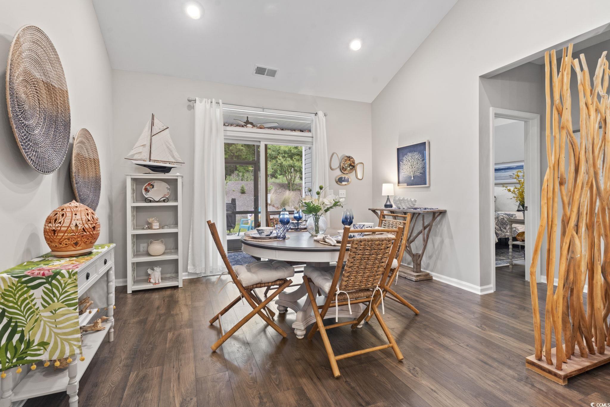 4027 Taranto Loop, Unit C Myrtle Beach, SC 29579 - Photo 14 of 36 Dining room featuring vaulted ceiling, dark wood f