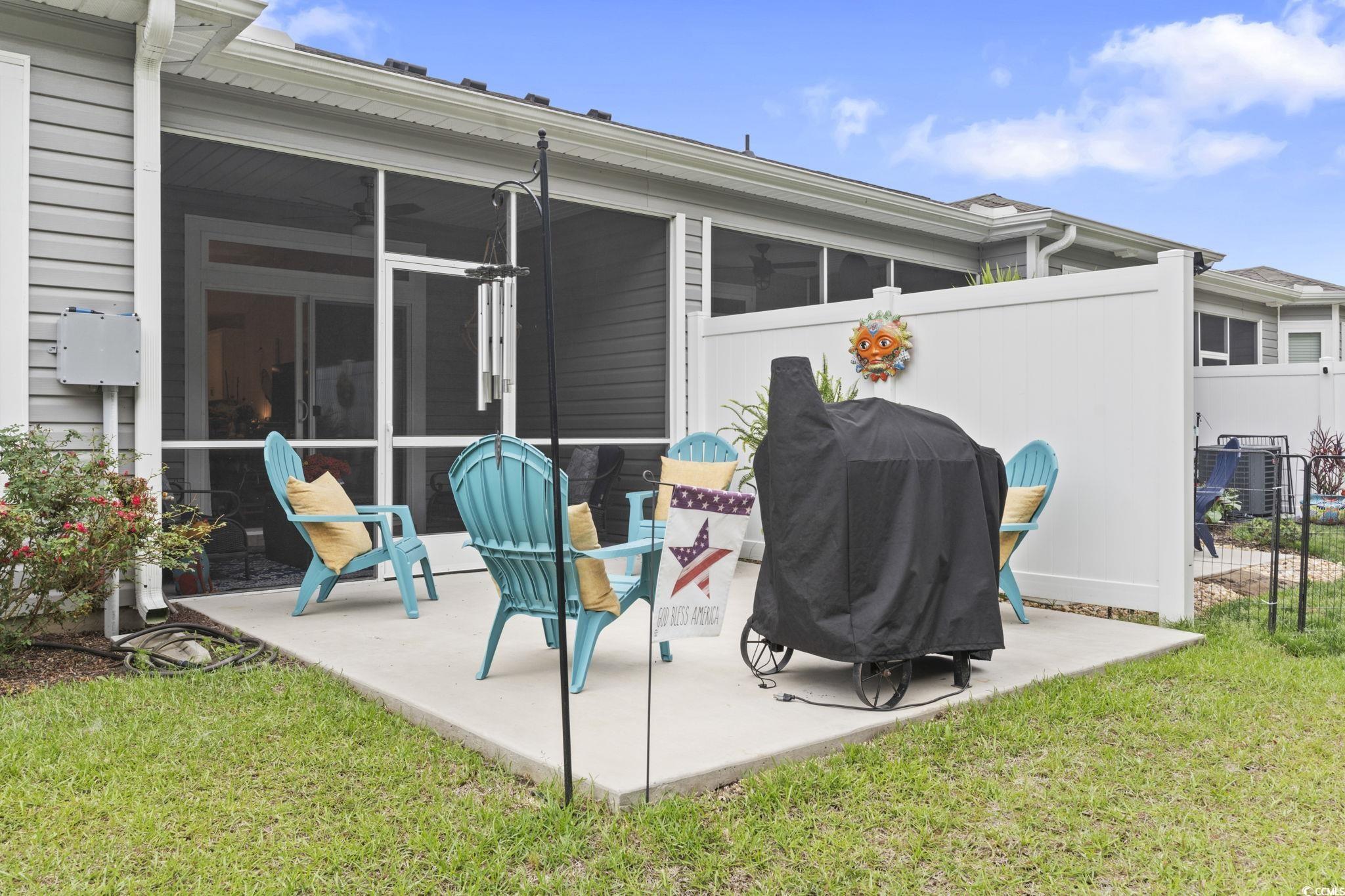 4027 Taranto Loop, Unit C Myrtle Beach, SC 29579 - Photo 25 of 36 Rear view of house featuring a patio, a sunroom, a