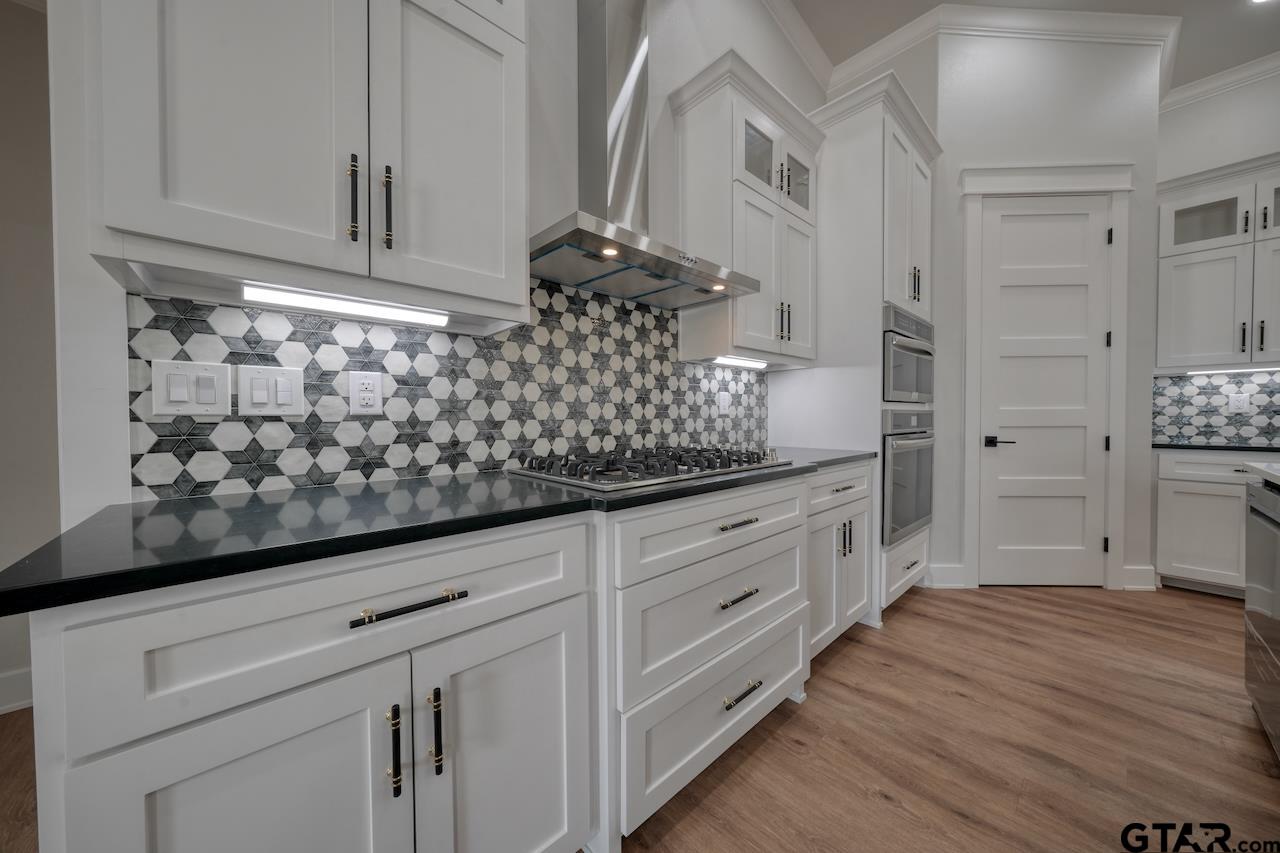 19383 Ridge Point Circle Lindale, TX 75771 - Photo 15 of 48 a kitchen with white cabinets and sink