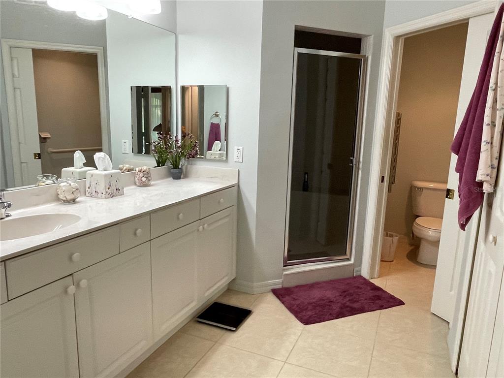 5000 Ibis Way, Unit 101 Venice, FL 34292 - Photo 14 of 39 a bathroom with a sink and a mirror