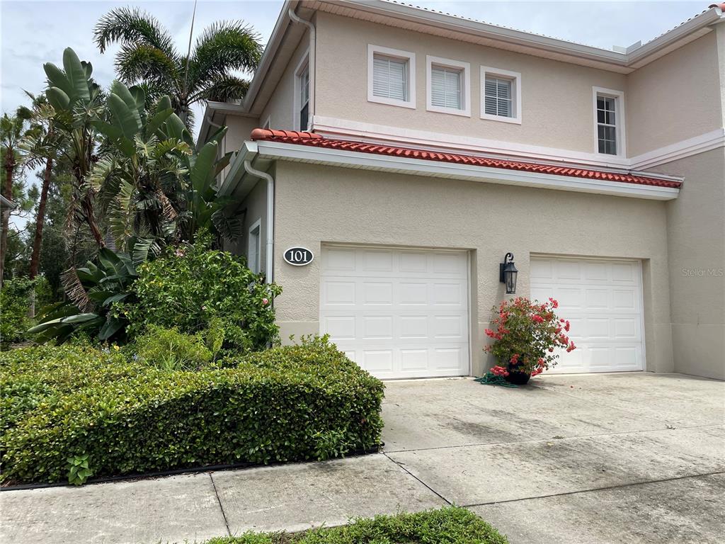 5000 Ibis Way, Unit 101 Venice, FL 34292 - Photo 23 of 39 a front view of a house with a yard