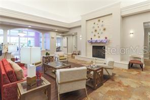 5000 Ibis Way, Unit 101 Venice, FL 34292 - Photo 28 of 39 a living room with fireplace furniture and a flat screen tv