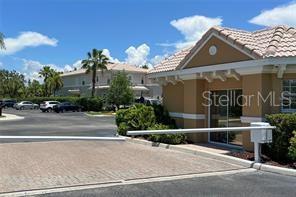 5000 Ibis Way, Unit 101 Venice, FL 34292 - Photo 38 of 39 a front view of a house with a yard and garage