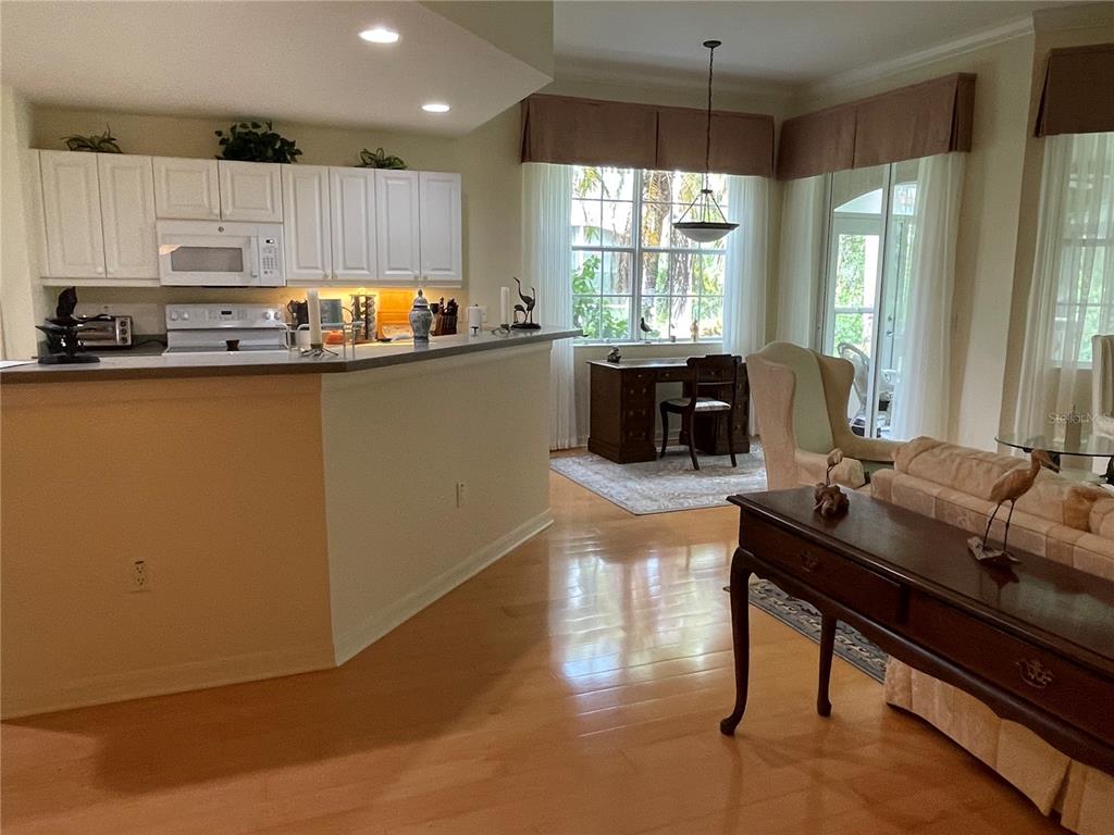 5000 Ibis Way, Unit 101 Venice, FL 34292 - Photo 4 of 39 a kitchen with kitchen island granite countertop a sink counter top space and stainless steel appliances