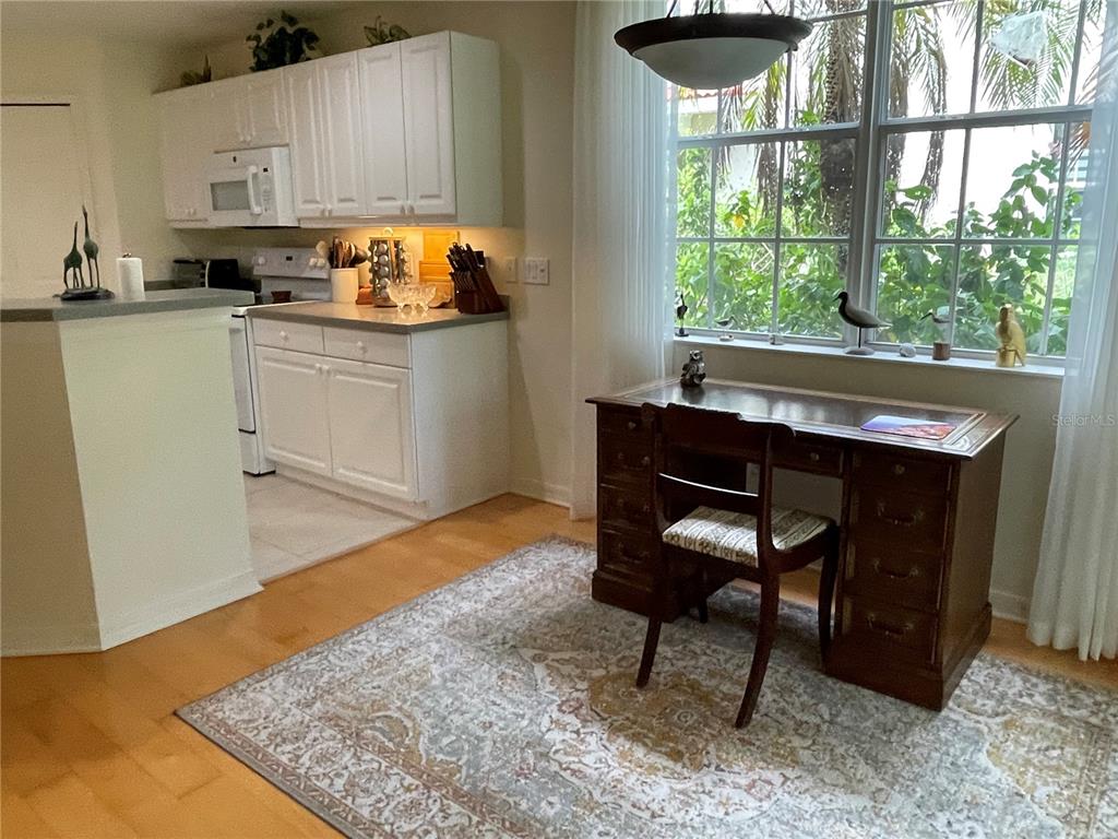 5000 Ibis Way, Unit 101 Venice, FL 34292 - Photo 5 of 39 a workspace with kitchen island a window and a sink