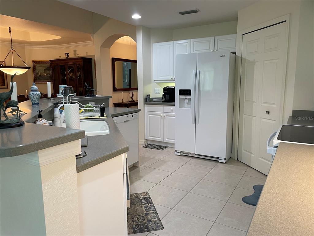 5000 Ibis Way, Unit 101 Venice, FL 34292 - Photo 8 of 39 a kitchen with stainless steel appliances a refrigerator and a sink