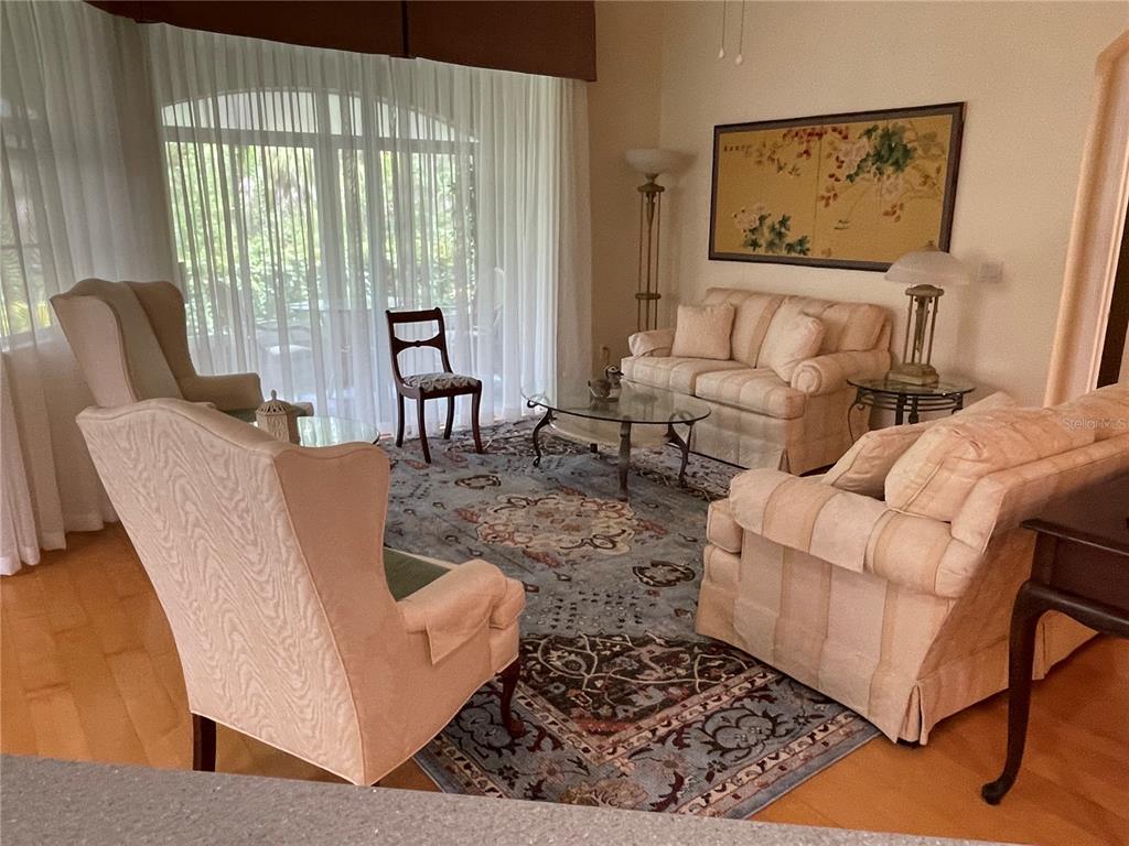 5000 Ibis Way, Unit 101 Venice, FL 34292 - Photo 9 of 39 a living room with furniture and a large window