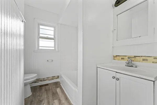 a bathroom with a sink toilet and tub