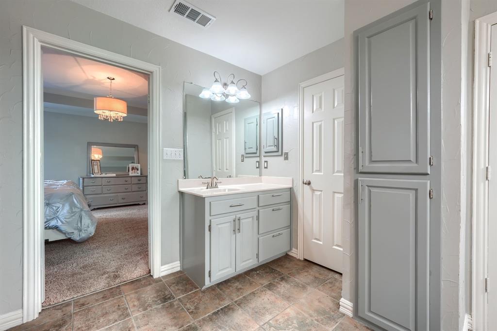 2592 Meadow Way Kaufman, TX 75142 - Photo 22 of 40 a bathroom with a double vanity sink and a mirror