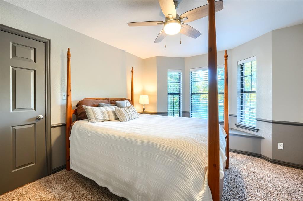 2592 Meadow Way Kaufman, TX 75142 - Photo 30 of 40 a bedroom with a large bed and a chandelier