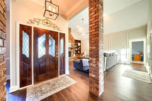 a living room with furniture chandelier and a fireplace