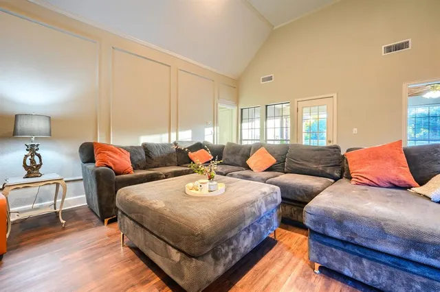 a living room with furniture and a potted plant