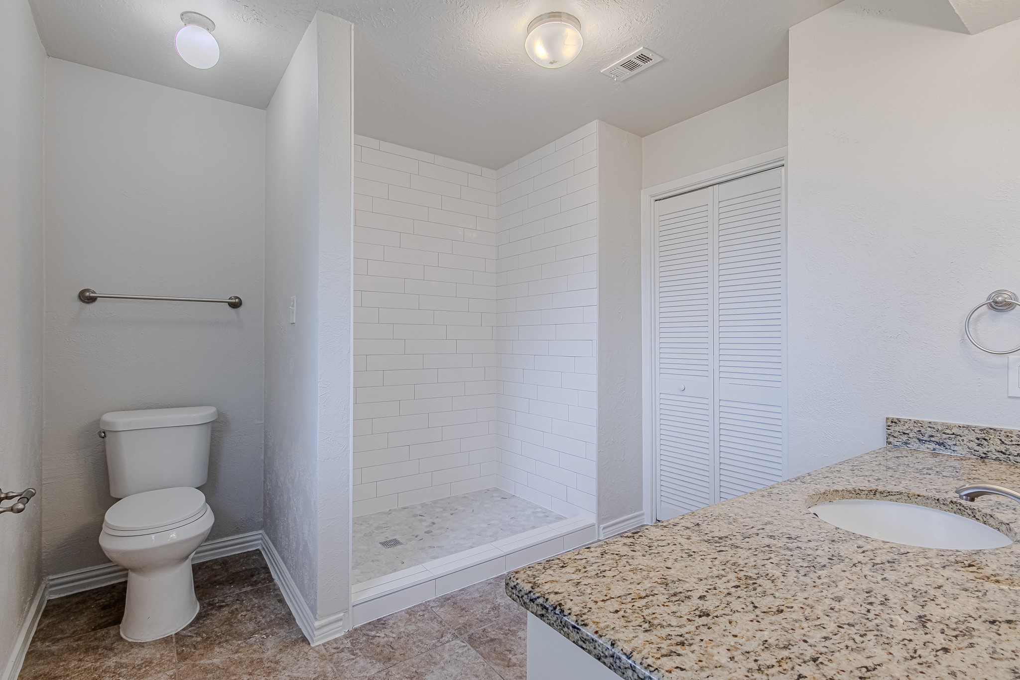 24306 Spring Mill Lane Spring, TX 77373 - Photo 16 of 24 a bathroom with a granite countertop toilet and a sink