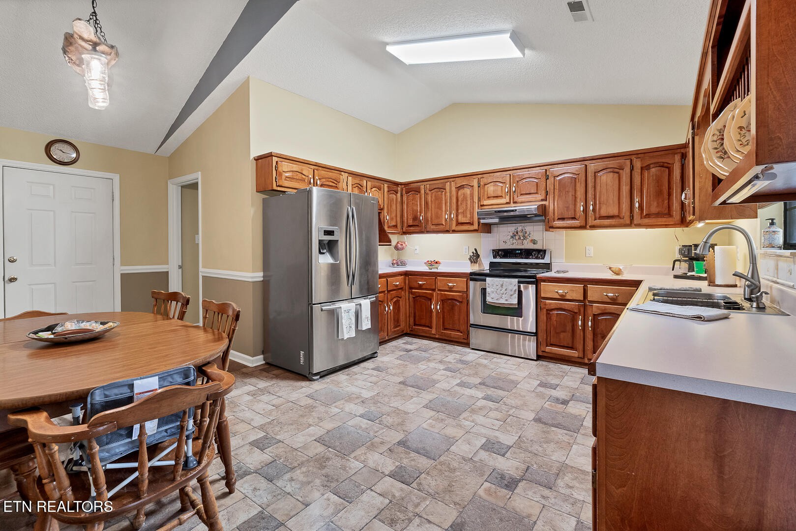 449 Foss Road Maryville, TN 37801 - Photo 18 of 49 a kitchen with stainless steel appliances granite countertop a sink refrigerator and cabinets
