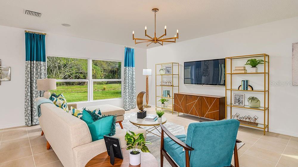 13811 Shellmore Avenue Palmetto, FL 34221 - Photo 14 of 17 a living room with furniture ceiling fan and a window