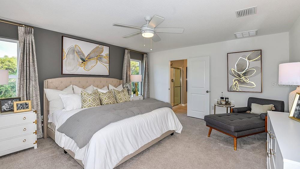 13811 Shellmore Avenue Palmetto, FL 34221 - Photo 16 of 17 a bedroom with a bed and a painting on the wall